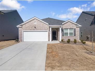 Charming single-story home features a two-car garage and classic brick facade at 2030 Vidalia Court, Dacula, GA 30019