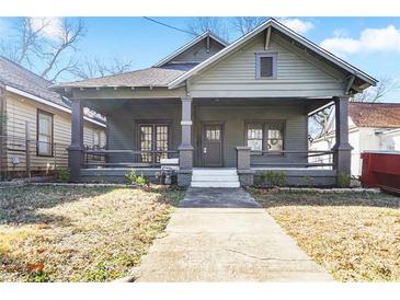 Charming home featuring a covered front porch with sturdy columns and fresh landscaping at 1050 Lawton Sw Ave, Atlanta, GA 30310