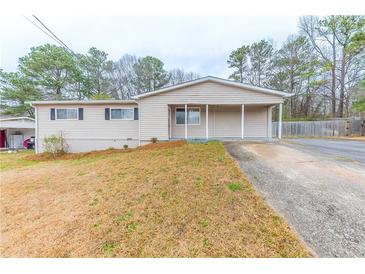 Charming one-story home featuring a covered porch and well-maintained front yard at 6202 Humphries Hill Rd, Austell, GA 30106