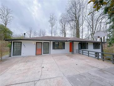 Charming single-story home featuring a welcoming entrance, a concrete driveway, and beautiful landscaping at 341 Baggett Cir, Lawrenceville, GA 30044