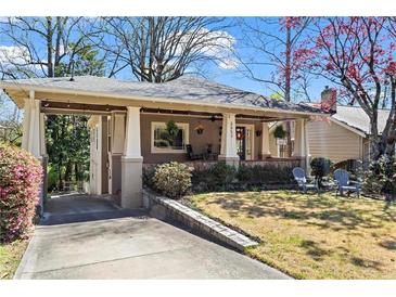 Charming home featuring a covered porch, well-manicured lawn, and inviting curb appeal at 2653 Brookwood Ne Dr, Atlanta, GA 30305