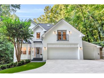 Stunning two-story white brick home with well-manicured landscaping and a private balcony at 3882 The Ascent Ne, Brookhaven, GA 30319