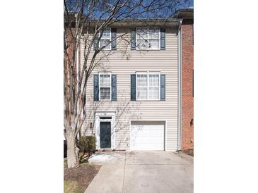 Charming townhouse with an attached garage and a well-manicured front yard at 5381 Briar Creek Ln, Norcross, GA 30071