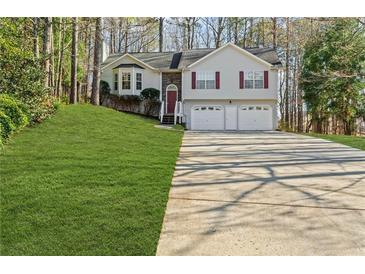 Charming two-story home with a two-car garage and a well-manicured lawn at 305 Bridgewater Ter, Canton, GA 30115