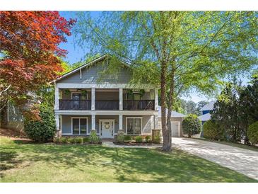 Charming two-story home with a welcoming front porch and beautifully landscaped front yard in a suburban setting at 2742 Oak Village Trl, Decatur, GA 30032