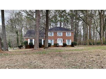 Charming two-story brick home with a well-maintained lawn and mature trees at 260 N Fayette Dr, Fayetteville, GA 30214