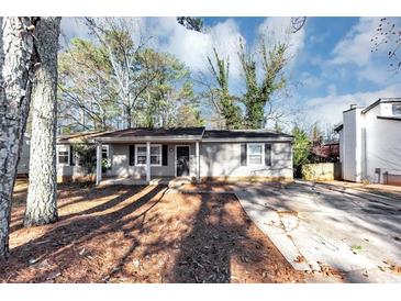 Charming single-story home with a well-maintained front yard and concrete driveway at 4275 Ridgetop Dr, Ellenwood, GA 30294