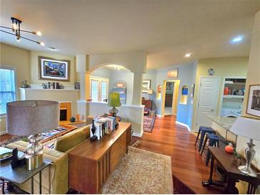 View of open-concept living room featuring hardwood floors and abundant natural light at 1349 Orchard Park Dr, Stone Mountain, GA 30083