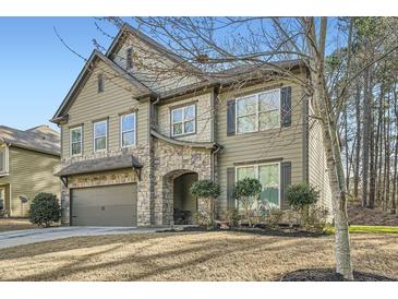 Beautiful two-story home featuring stone accents, manicured landscaping, and an attached two-car garage at 316 Silverwood Dr, Dallas, GA 30157