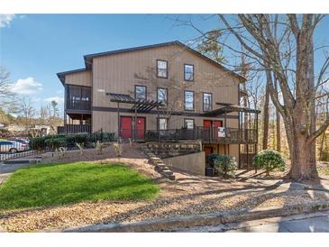 Two-story exterior with a small front yard and pergola covered walkways at 408 River Run Dr, Atlanta, GA 30350