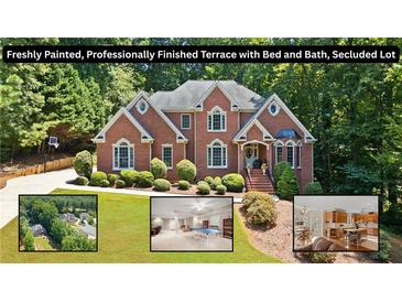 Stately brick home featuring mature landscaping and a freshly painted terrace at 2287 Lake Ridge Ter, Lawrenceville, GA 30043