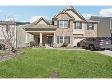 Charming two-story brick home featuring a well-manicured front yard and attached garage at 3546 Bridge Walk Dr, Lawrenceville, GA 30044