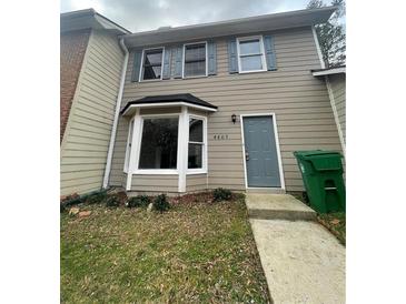 Inviting townhome featuring neutral siding, bright windows, and a well-maintained front yard at 4807 Hairston, Stone Mountain, GA 30088