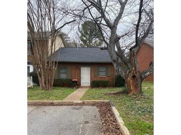 Charming brick home featuring a well-maintained lawn and mature trees in a tranquil neighborhood setting at 4762 Old Highgate Entry, Stone Mountain, GA 30083