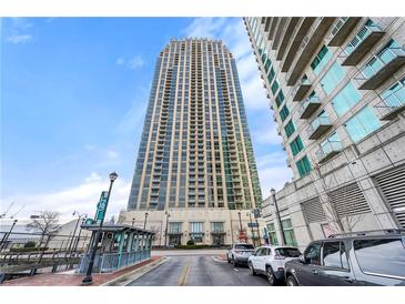 Modern high-rise condominium exterior showcasing its impressive height against a clear, blue sky at 270 17Th Nw St # 2804, Atlanta, GA 30363