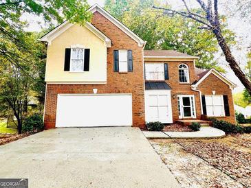 Charming two-story home with a brick facade, a two-car garage, and mature trees in a well-maintained neighborhood at 120 Croftwood Ct, Johns Creek, GA 30097