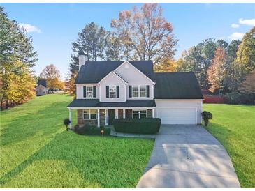 Charming two-story home with a well-manicured lawn and inviting front porch at 12 Windcrest, Covington, GA 30016