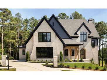 Stunning two-story brick home with manicured lawn and black trim at 6055 Tattnall Overlook, Acworth, GA 30101