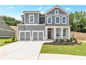 Charming two-story home featuring a two-car garage, stone accents, and a well-manicured front lawn at 333 Willow Cv, Canton, GA 30114