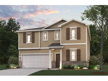 Charming two-story home featuring neutral siding, decorative shutters, and an attached two-car garage at 5523 Rosehall Pl, Atlanta, GA 30349