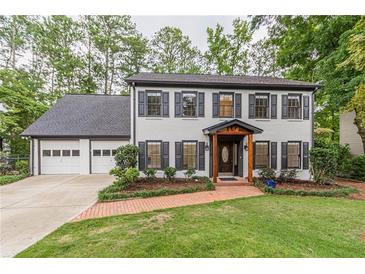 Charming two-story home with painted brick, black shutters, and a well-manicured lawn at 2911 Bentwood Dr, Marietta, GA 30062