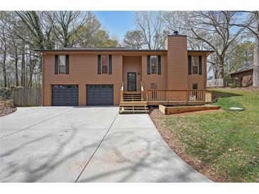 Charming home featuring a two-car garage, a cozy deck, and a well-maintained front yard at 1072 Powell Wright Rd, Marietta, GA 30066
