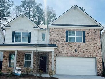 Charming two-story home with a brick facade, white accents and a two car garage at 793 River Gardens Dr, Atlanta, GA 30354