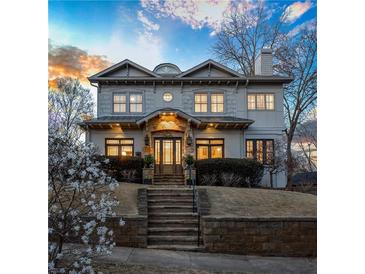 Beautiful two-story home with manicured landscaping and a welcoming stone staircase at 1100 Virginia Ne Ave, Atlanta, GA 30306