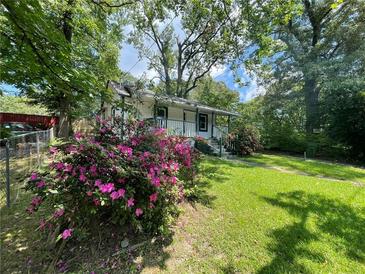 Well-maintained home exterior framed by trees at 1199 Warfield Nw St, Atlanta, GA 30318