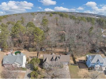 A captivating aerial view of the property nestled amongst a lush forest setting at 742 Wilkes Dr, Loganville, GA 30052