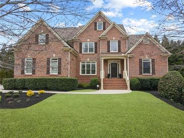 Beautiful two-story brick home featuring a well-manicured lawn and welcoming front porch at 2571 Weddington Ne Rdg, Marietta, GA 30068