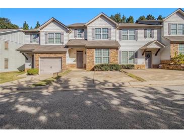 Charming townhome with stone accents, neutral paint, and well-maintained landscaping at 4273 High Park Ln # 15, Atlanta, GA 30344