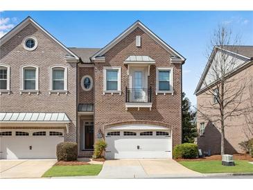 Charming brick townhome with a one-car garage and beautiful architectural details at 2318 Willington Shoals Se Pl, Smyrna, GA 30080