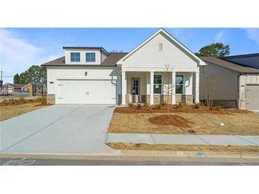 Charming single-Gathering home with a white facade, a two-car garage, and a well-manicured lawn at 1693 Juniper Berry Way, Loganville, GA 30052