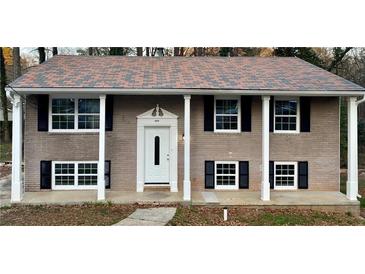 Charming brick home with a cozy front porch and black shutters at 1032 Brian Ln, Forest Park, GA 30297