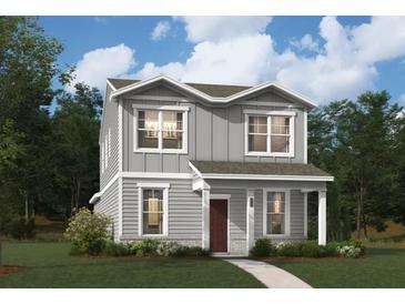 Charming two-story home with gray siding, trimmed windows, and a landscaped front yard at 604 Devon Aly, Acworth, GA 30102