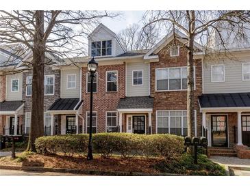 Charming townhomes featuring varied exteriors of brick, stone, and siding, creating a unique streetscape at 1175 Glenridge Pl, Atlanta, GA 30342