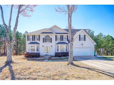 Traditional two-story home boasting a two-car garage and well-manicured landscaping at 6219 Wurtenburg Ct, Stone Mountain, GA 30087