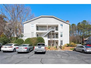 Exterior view of a light grey building, with a central staircase leading to the upper floors and parking in front at 1321 Keys Lake Ne Dr, Brookhaven, GA 30319