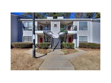 Attractive condo complex featuring neat landscaping, symmetrical stairs, and neutral paint at 586 Windchase Ln, Stone Mountain, GA 30083