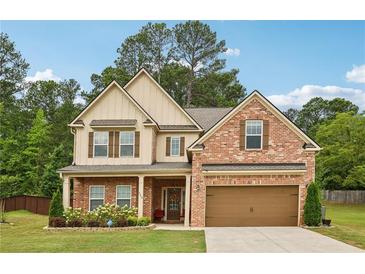 Charming two-story brick home with a well-manicured lawn and attached two-car garage at 244 Lotus Cir, Mcdonough, GA 30252