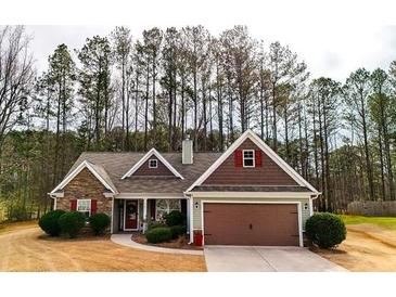 Charming single-story home with stone accents, a manicured lawn, and a two-car garage at 28 Butler Park Ct, Dallas, GA 30157