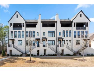 Charming new construction townhomes feature brick exteriors, private balconies, and landscaped front yards at 714 Opera Ln, Alpharetta, GA 30009