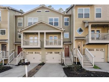 Townhome with private garages, elevated entrances and front balconies in a well-maintained community at 1096 Liberty Nw Pkwy, Atlanta, GA 30318