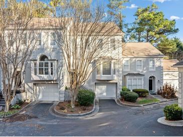 Charming townhome with a two-car garage, a well-maintained yard, and classic architectural details at 1532 Oak Grove Rd, Decatur, GA 30033