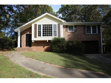 Charming brick home featuring a large picture window and a well-maintained front yard at 2491 Hatfield Cir, Atlanta, GA 30316