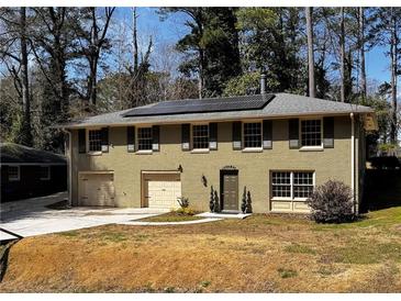 Charming two-story home with brick facade, solar panels and attached garages at 3087 Meadow Lark Ln, East Point, GA 30344