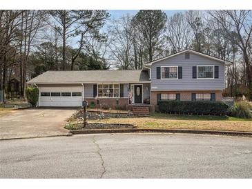 Charming two-story home featuring a well-maintained front yard with established landscaping at 2690 Manassas Pl, Snellville, GA 30039