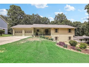 Charming ranch-style home with a well-maintained lawn and inviting front porch at 3231 Boulder Brook Dr, Lithonia, GA 30038