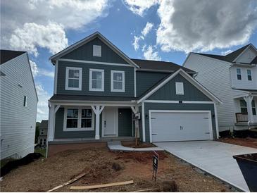 Charming two-story home with a covered front porch and attached two-car garage at 41 Okeechobee Way, Braselton, GA 30548